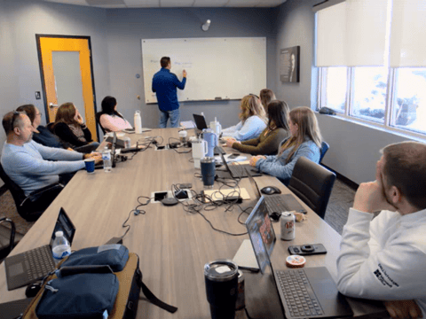 Interlink team members at conference table during Matt Sherocman's presentation